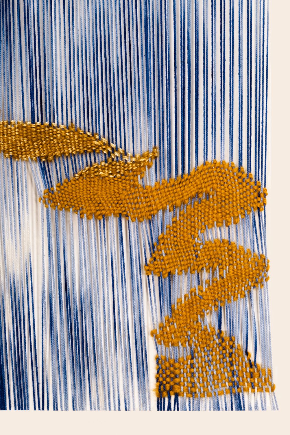 Detail of It is a Journey: the ochre line folding back on itself at the right edge, over open blue and white warp