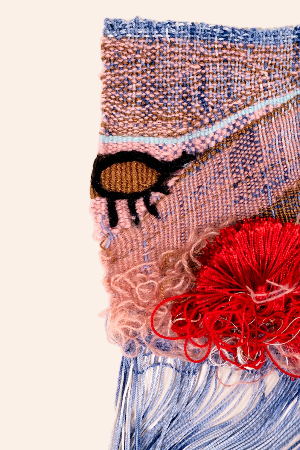 Detail of The Air is Fragrant: pink and blue woven ground with a pale blue line, a black-outlined figure with an ochre body, and a red tassel above curly pink mohair