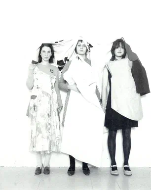 All Events Are Even, page 2: black-and-white photograph of three young women together, draped overhead in white fabric, in mismatched layered outfits