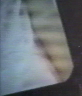 Asymptote: Flux, page 223: full-page abstract blurred photograph in pale blue-green tones fading to a dark diagonal edge, no discernible subject