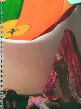Thoughts Play Hide & Seek, page 181: a full-page photograph of two people lying on the floor beneath a yellow panel painted with a tree silhouette, next to a shiny magenta fabric panel
