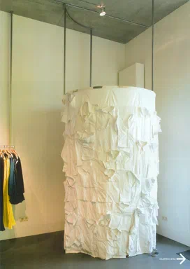 WeAr, Summer 2005, page A: full-page photograph of a shop interior with a floor-to-ceiling cylindrical installation of draped white shirts, beside a rack of black and yellow garments